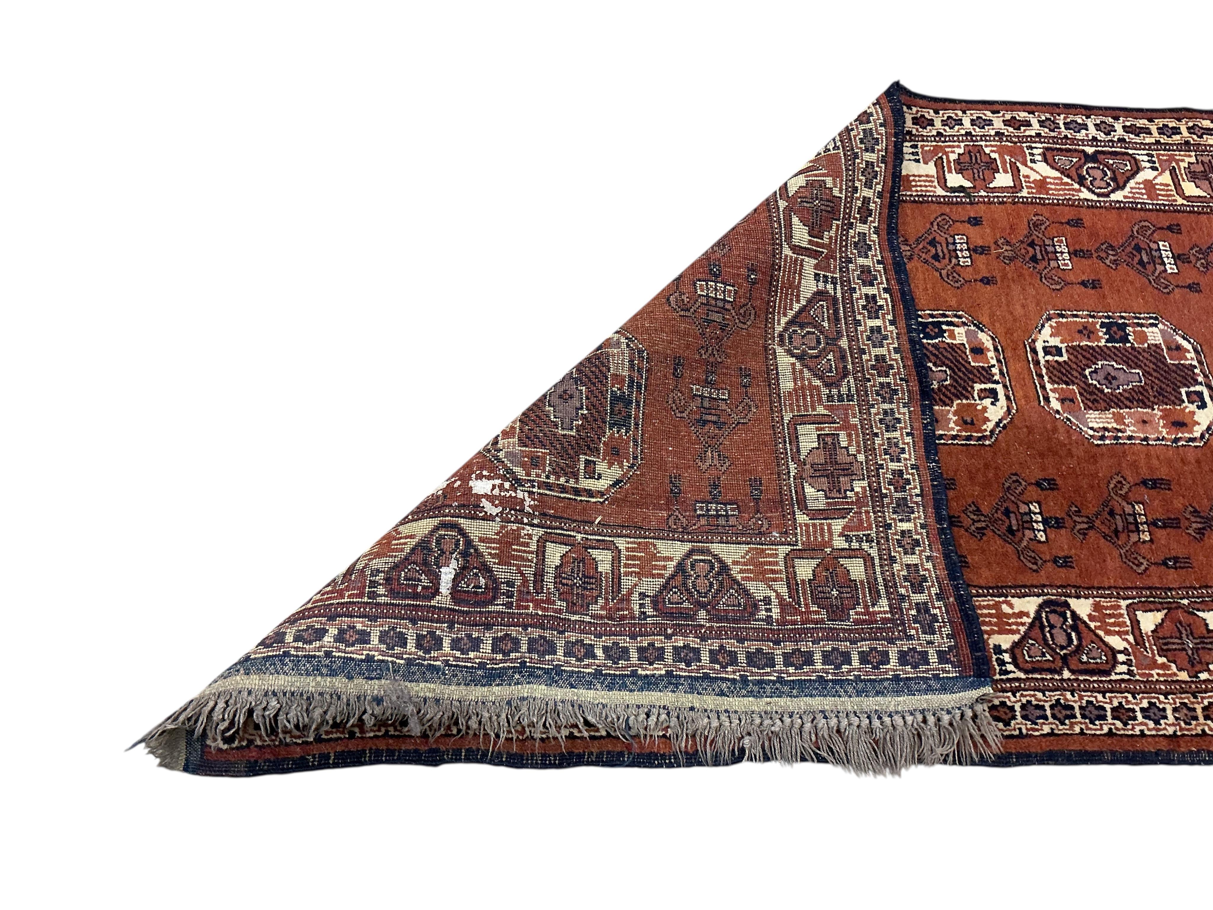 An Afghan red ground runner, 300 x 82cm and a rug, (worn)